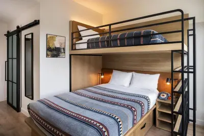 two bunk beds in a room with a bed at Moxy Boulder University in Boulder