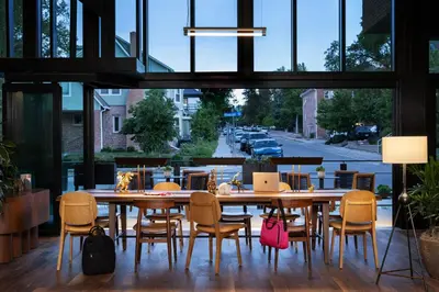 a dining room with a table and chairs at Moxy Boulder University in Boulder