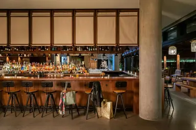 a bar with a lot of bar stools at Moxy Boulder University in Boulder