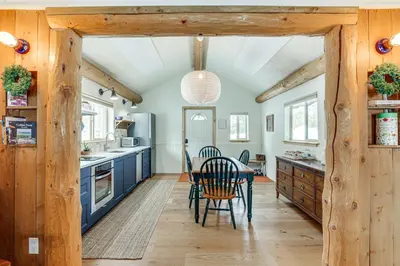 a kitchen with blue cabinets and a table and chairs at 3 Mi to Rocky Mtn Natl Park Grand Lake Cabin in Grand Lake