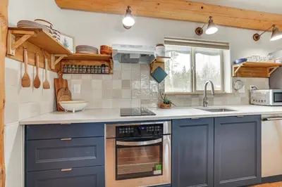 a kitchen with blue cabinets and a sink at 3 Mi to Rocky Mtn Natl Park Grand Lake Cabin in Grand Lake