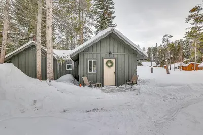 a small house with a wreath on the door in the snow at 3 Mi to Rocky Mtn Natl Park Grand Lake Cabin in Grand Lake