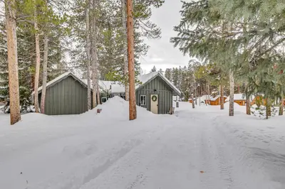 a snow covered road with two buildings and trees at 3 Mi to Rocky Mtn Natl Park Grand Lake Cabin in Grand Lake
