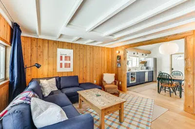a living room with a blue couch and a table at 3 Mi to Rocky Mtn Natl Park Grand Lake Cabin in Grand Lake