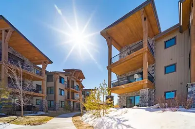 a large building with snow on the ground at NEW Condo Grand Park W/Hot Tub & Mountain View in Fraser