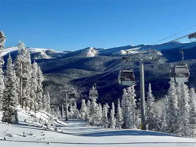 a ski lift with snow covered trees on a mountain at NEW Condo Grand Park W/Hot Tub & Mountain View in Fraser
