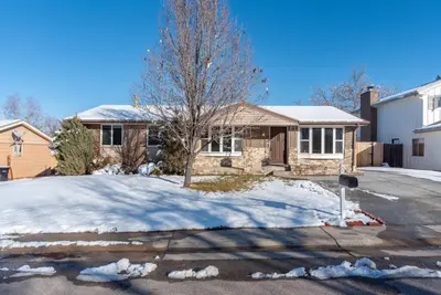 a house with a tree in the snow at Downtown Denver: 4bd - Game/Movie Room - Backyard in Arvada