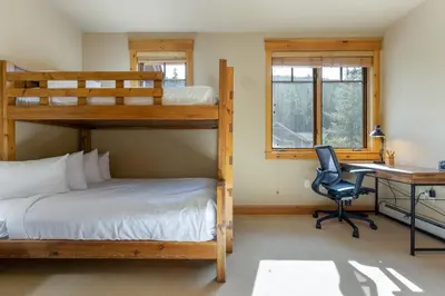 a bedroom with two bunk beds and a desk at 6554 Settlers Creek townhouse in Keystone