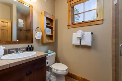 a bathroom with a sink and a toilet and a mirror at 6554 Settlers Creek townhouse in Keystone