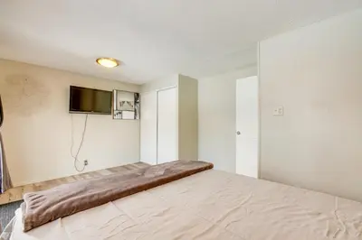 a bedroom with a large bed and a flat screen tv at Covered Patio, Gas Grill and Yard Sheridan Home! in Sheridan
