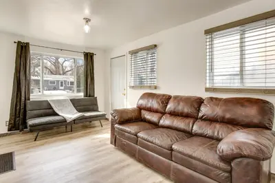 a living room with a brown leather couch at Covered Patio, Gas Grill and Yard Sheridan Home! in Sheridan