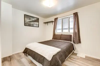 a small bedroom with a bed and a window at Covered Patio, Gas Grill and Yard Sheridan Home! in Sheridan