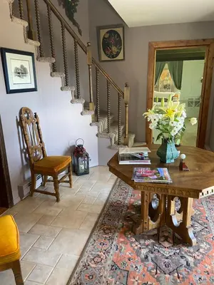 a living room with a table and a staircase at Colorado Bed & Breakfast with beautiful views in Evergreen