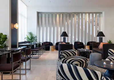 a lobby with couches and tables and chairs at Kimpton Claret Hotel by IHG in Denver