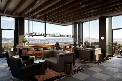 a lobby with chairs and a bar with a view at Kimpton Claret Hotel by IHG in Denver