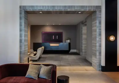 a lobby with a couch and a reception desk at Kimpton Claret Hotel by IHG in Denver