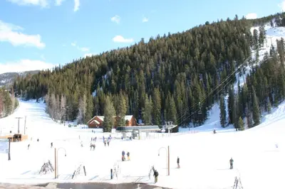 a group of people skiing down a snow covered mountain at Gateway Lodge 5027 by SummitCove Lodging in Keystone