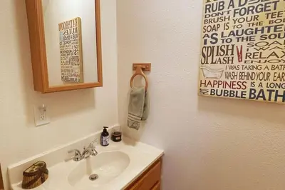 a bathroom with a sink and a mirror at Shady Pines- Cozy Mountain Retreat in Idaho Springs
