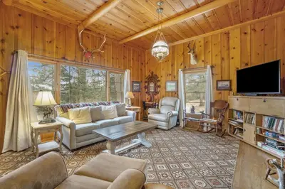 a living room with a couch and a tv at Hidden Pines -- EV#3034 home in Estes Park