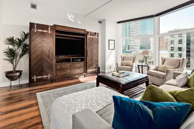 a living room with a couch and a tv at Larimer Square Luxury - Office - Downtown Hub in Denver