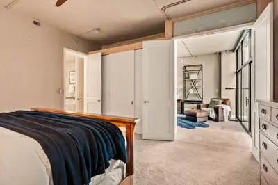 a bedroom with a bed and a living room at Larimer Square Luxury - Office - Downtown Hub in Denver