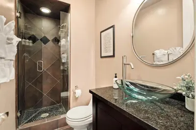 a bathroom with a glass bowl sink and a shower at Larimer Square Luxury - Office - Downtown Hub in Denver