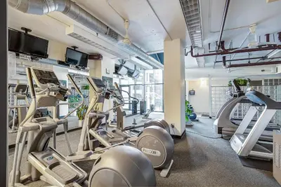 a gym with several treadmills and ellipticals at Larimer Square Luxury - Office - Downtown Hub in Denver
