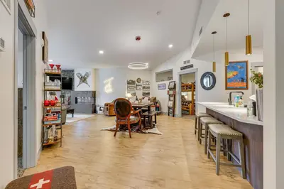a room with a table and chairs and a kitchen at Downtown Winter Park Condo about 3 Mi to Skiing! in Winter Park