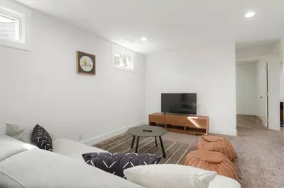 a living room with a couch and a tv at 5-Bedrooms! Stylish and Modern Home, Pets Welcome! in Arvada