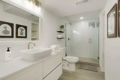 a white bathroom with a sink and a toilet at 5-Bedrooms! Stylish and Modern Home, Pets Welcome! in Arvada