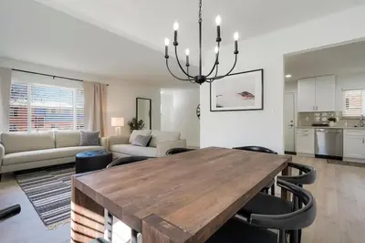 a dining room and living room with a table and chairs at 5-Bedrooms! Stylish and Modern Home, Pets Welcome! in Arvada