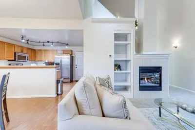 a living room with a couch and a fireplace at 12 Mi to DIA Cozy Denver Townhome with Fireplace! in Aurora