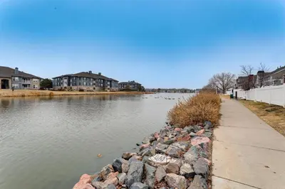 a body of water with some rocks and houses at 12 Mi to DIA Cozy Denver Townhome with Fireplace! in Aurora