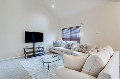 a living room with two white couches and a flat screen tv at 12 Mi to DIA Cozy Denver Townhome with Fireplace! in Aurora