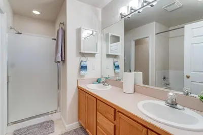 a bathroom with two sinks and a shower at 12 Mi to DIA Cozy Denver Townhome with Fireplace! in Aurora