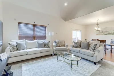 a living room with two couches and a glass table at 12 Mi to DIA Cozy Denver Townhome with Fireplace! in Aurora