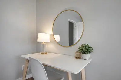a white desk with a lamp and a mirror at Serene 4-Bedroom Getaway in Arvada! Pet-friendly! in Arvada