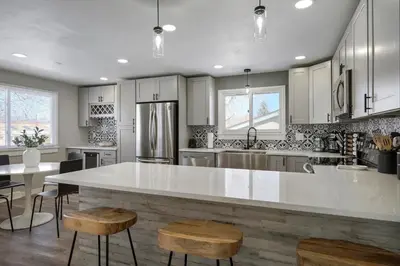 a large kitchen with a large white counter top at Serene 4-Bedroom Getaway in Arvada! Pet-friendly! in Arvada