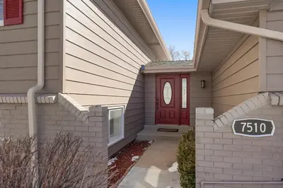 a house with a red door with a sign on it at Serene 4-Bedroom Getaway in Arvada! Pet-friendly! in Arvada