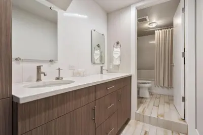 a bathroom with a sink and a toilet at Elegant Oasis - Fireplaces, King Beds, Mtn Views! in Fort Collins
