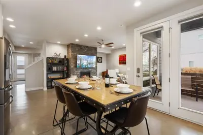 a kitchen and dining room with a table and chairs at Elegant Oasis - Fireplaces, King Beds, Mtn Views! in Fort Collins