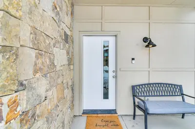 a blue bench sitting on the front porch of a house at Granby Retreat with Community Pool Ski-InandSki-Out! in Granby
