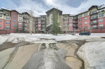 a parking lot with snow in front of a building at Granby Retreat with Community Pool Ski-InandSki-Out! in Granby