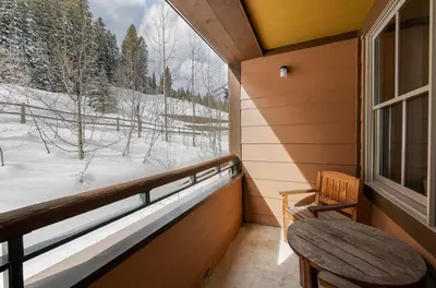 a porch with a bench and a window with a view at Premium Unit 1301 - 1 Bedroom - Zephyr Mtn Lodge condo in Winter Park
