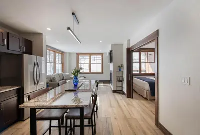 a kitchen and living room with a table and a bed at Premium Unit 1301 - 1 Bedroom - Zephyr Mtn Lodge condo in Winter Park
