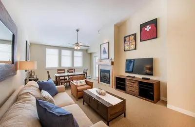 a living room with a couch and a tv at Select Unit 3606 - Fraser Crossing Founders Pointe condo in Winter Park