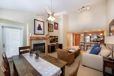 a living room with a dining table and a fireplace at Select Unit 3606 - Fraser Crossing Founders Pointe condo in Winter Park