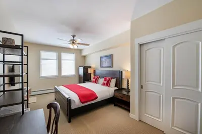a bedroom with a bed with red pillows on it at Select Unit 3606 - Fraser Crossing Founders Pointe condo in Winter Park