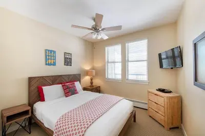 a bedroom with a bed and a ceiling fan at Select Unit 3606 - Fraser Crossing Founders Pointe condo in Winter Park