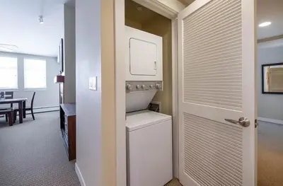 a kitchen with a washer and dryer next to a door at Select Unit 3606 - Fraser Crossing Founders Pointe condo in Winter Park